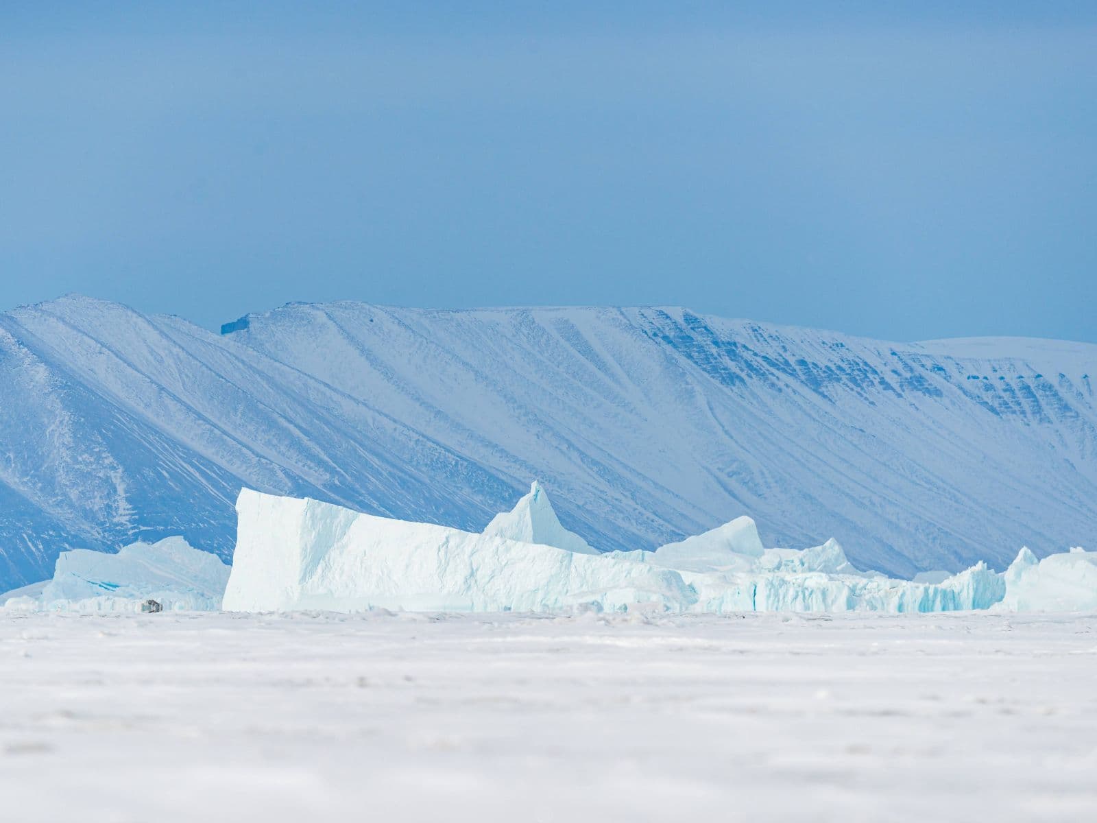 Split image showing Antarctic landscape and Arctic ice